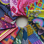 Collection of colorful fabric swatches arranged in a circular pattern. Anna Maria Fabric | Fat Quarter Bundle 1 