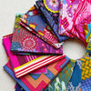 Collection of colorful fabric swatches arranged in a circular pattern. Anna Maria Fabric | Fat Quarter Bundle 1 