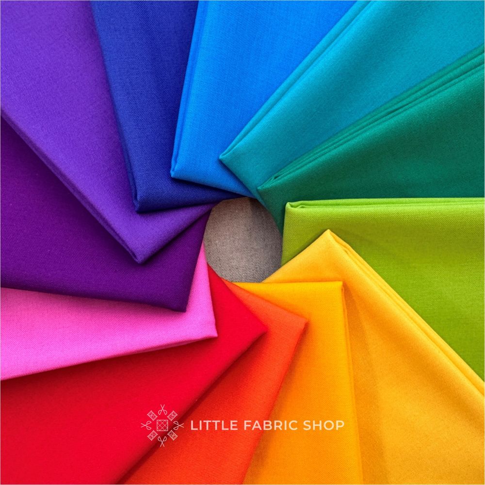 Colorful fabric swatches arranged in a circular pattern on a gray background with 'Little Fabric Shop' branding. Rainbow Bella Solids Fat Quarter Bundle | Moda Fabrics