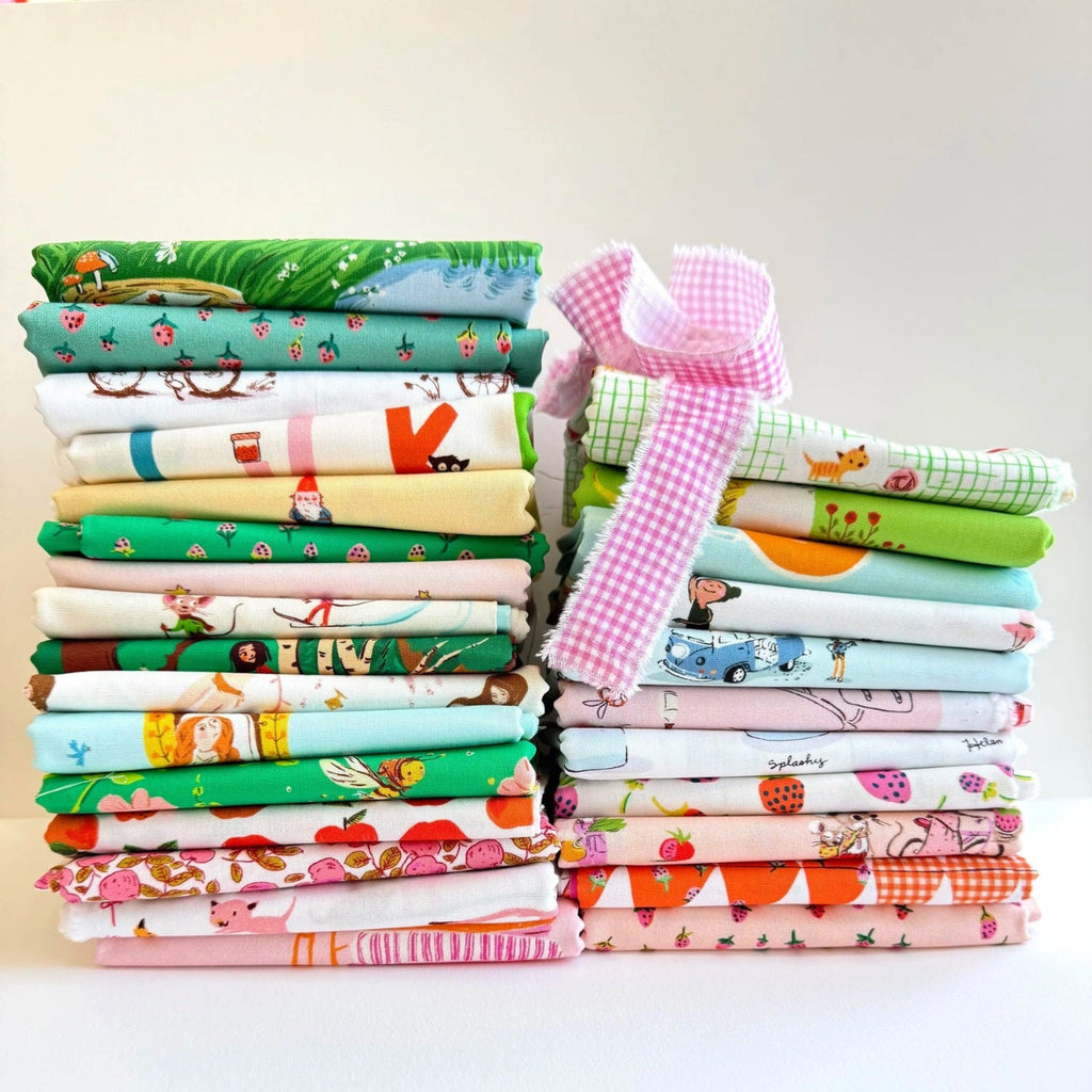 Collection of colorful fabric rolls with various patterns on a gray background | Heather Ross Favorites | Windham Fabrics | Fat Quarter Bundle